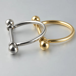 Piercing barbell com arco liso em acabamento prateado e dourado