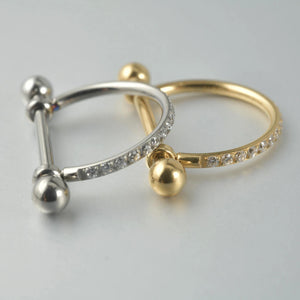 Piercing barbell com arco cravejado em zircônias nas cores prata e dourado