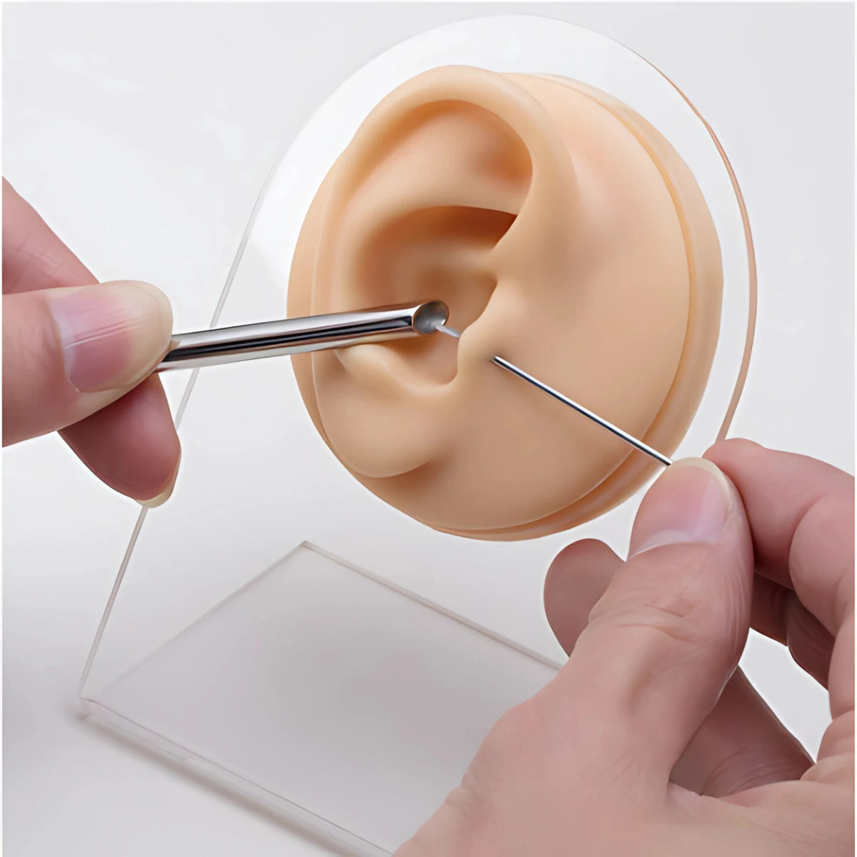 Tubo guia receptor sendo posicionado durante procedimento de piercing na orelha